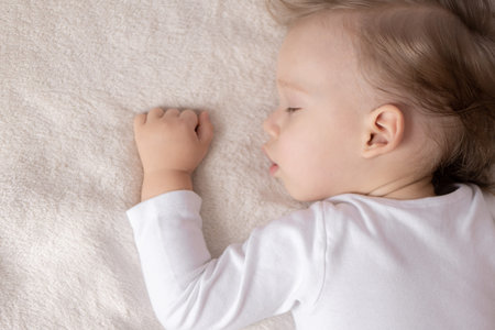 Childhood, sleep, rest, family, lifestyle concept - close-up portrait of a cute little boy of 2...