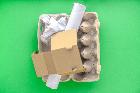 garbage, ecology, garbage sorting concept - layout of waste sorting into 4 types: glass, plastic, paper, metal on a green background copy space.の写真素材