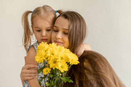 motherhood, mothers day, birthday, childhood, family concept - close-up little girl in blue colorful...
