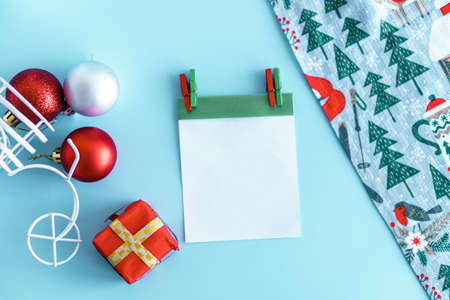 Xmas, winter, new year concept - Blue Christmas background with gift box tree toys red, gold and white color, towel. toy bike with trunk carries box from Santa. Flatly, top view, overhead. Copy spaceの写真素材