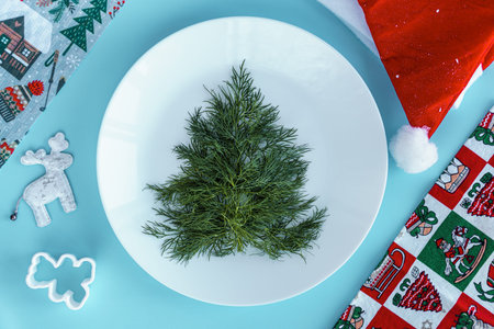 Xmas, winter, new year, festive table and treats, food concept - Blue background with lush dill...