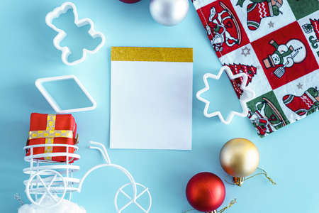 Blue Christmas background with gift box, fir tree branch, clew of rope, wrapping paper roll. Christmas, winter, new year concept. Flat lay, top view, overheadの写真素材