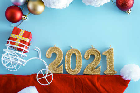 Blue Christmas background with gift box, fir tree branch, clew of rope, wrapping paper roll. Christmas, winter, new year concept. Flat lay, top view, overhead.の写真素材