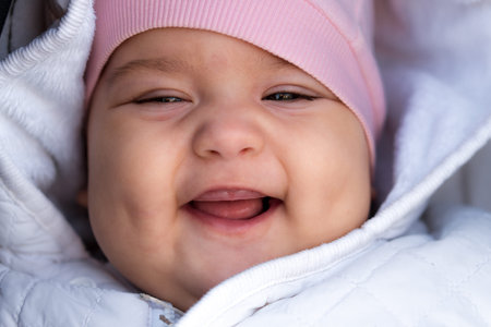 infant, childhood, emotion concept - close-up of cute smiling portrait face of brown-eyed chubby...