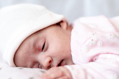 Childhood, care, motherhood, health concepts - Close up Little peace calm newborn baby girl in pink...