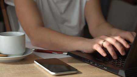 Close Up Hands Of Young Woman Chatting On Laptop At Home In Living Room. Writing Searching Using IT...