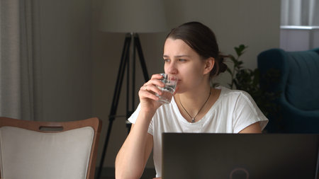 Authentic Stressful Woman working Chatting On Laptop Living Room. Writing Searching Using IT. Tired Sad Lady Working On Computer Internet On Comfortale Chair. Buisenes, Education, Technology Conceptの写真素材