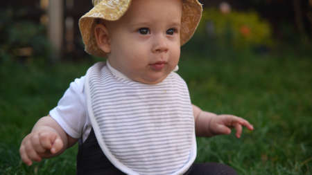 Happy Baby Sitting With Soccer Black White Classic Ball On Green Grass. Adorable Infant Baby Playing Outdoors In Backyard Garden. Little Children With Parents. Football, Championship, Sport Conceptの写真素材