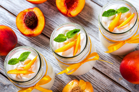 delicious homemade yogurt with pieces of peach, top viewの写真素材