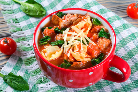 tortellini soup with italian sausages, spinach, tomato, parmesan cheeseの写真素材