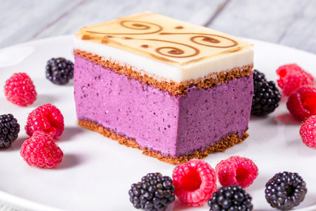 a piece of cake souffle with blackberries, raspberries, closeup