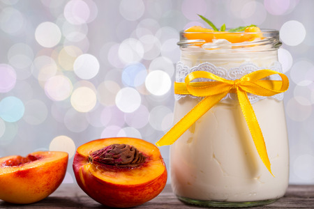 yogurt with peaches, bokeh background, closeupの写真素材