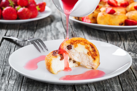 Delicious Cottage cheese pancakes with raisins and strawberriesの写真素材