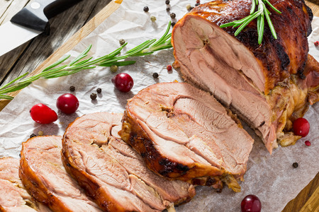 delicious roast  in oven turkey roulade cut in slices. spices, cranberry, rosemary on cutting board, knife on old wooden background, view from above, close-upの写真素材
