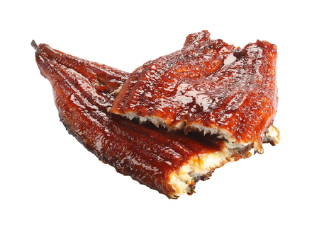 two pieces of grilled unagi fillet or eel with soy sauce isolated on white background, asian cuisine, close-upの写真素材