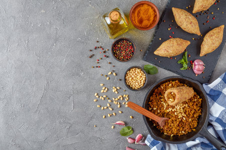 uncooked kibbeh of ground beef meat mixed with bulgur, fried minced meat with pine nuts, spices ,...