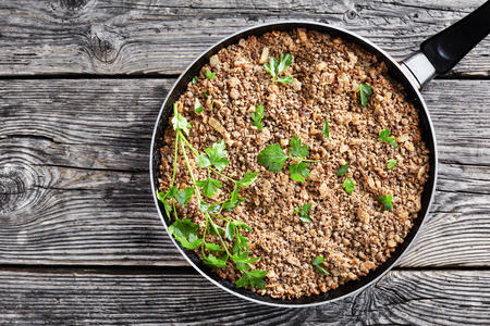 mixture for filling of pierogi and crepes of ground liver with onion and spices, fried in a skillet, view from above, flat layの写真素材