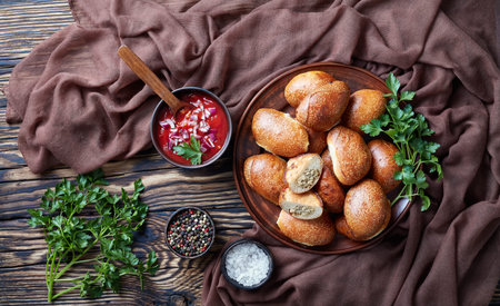 freshly baked bread dough turnovers with ground pork and chicken meat filling, portable pocket...
