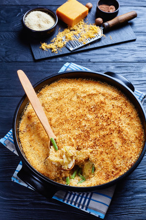 creamy and cheesy Potato and green bean Casserole with bread Crumbs Topping in a black dish, ...