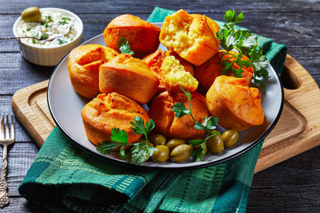 Balkan cornbread proja of cornmeal, yogurt, and eggs served on a blue plate with cream cheese, fresh...