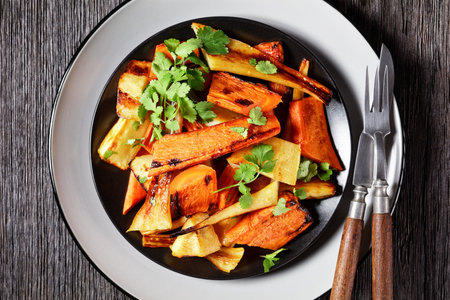 Moroccan roasted root vegetables: parsnip and carrot with ras el hanout spice: cinnamon, turmeric,...