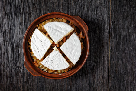 Tartiflette, French Potato, Bacon, and Cheese Casserole  prepared to bake in a clay dish, flat lay, free space,  french cuisineの写真素材