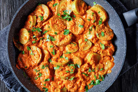 zucchini braised in a creamy tomato sauce in a pan, italian cuisine, flat lay, close-upの写真素材