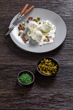 Oeuf mayonnaise, hard boiled eggs covered with a sauce consisting of mayonnaise garnished with...