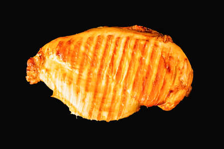 whole grilled chicken breast on black backgroundの写真素材