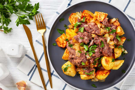 Yankee Pot Roast, Pot Roast of stewed tender beef potatoes and onion on a plate on a white wooden table, american cuisine, flat lay, close-upの写真素材