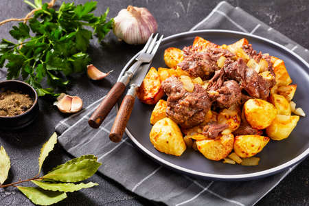 Pot Roast, Yankee Pot Roast of stewed tender beef potatoes and onion on a plate on a concrete table, american cuisine, horizontal viewの写真素材