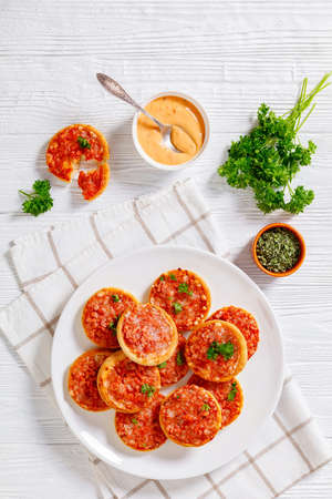 mini pizzas with ham and pecorino cheese, top viewの写真素材