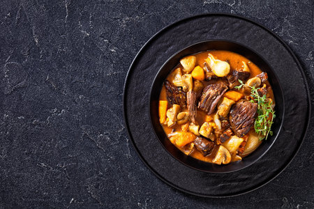 Beef Bourguignon, Beef Burgundy, stew with beef, bacon, carrots, onions and mushrooms slow cooked in...