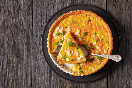 chicken salad hot pie, Pineapple Chicken Pie with almonds and cheese in baking dish on dark wooden table, horizontal view from above, flat lay, free spaceの写真素材