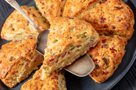 freshly baked Ham and cheese triangle American scones on platter, close-up, Dutch angle viewの写真素材