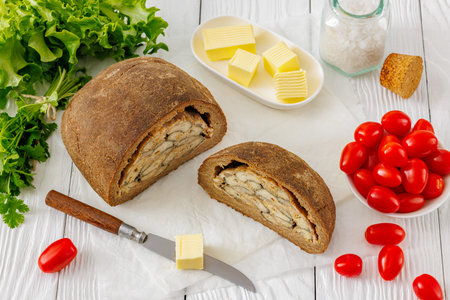 Traditional Finnish Kalakukko, fish pie with filling of Muikku vendace fish baked inside the dark...