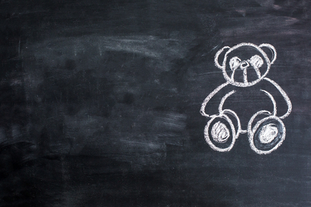 Teddy Bear toy alone on chalkboardの写真素材