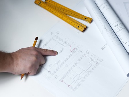 Business man draw buildings and present his architectural projectの写真素材