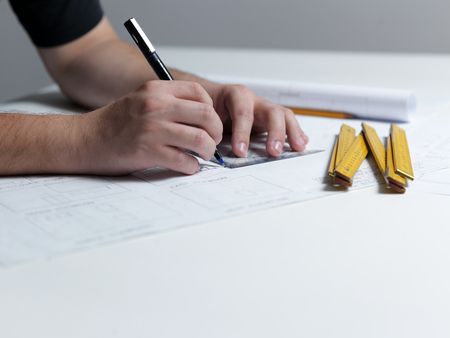 Business man draw buildings and present his architectural projectの写真素材