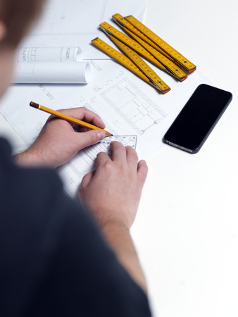 Business man draw buildings and present his architectural projectの写真素材