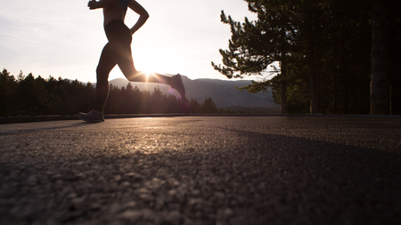 Active young woman jumping with skipping rope outdoorsの写真素材