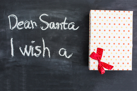 Dear Santa is written on a blackboard and christmas decorationの写真素材