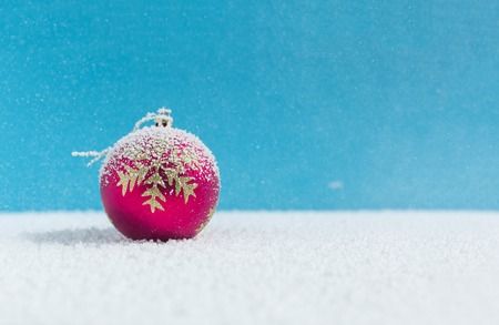 Christmas balls on snow, falling snowの写真素材
