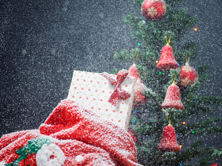 Photo of luxury gift boxes under Christmas tree, New Year home decorations, golden wrapping of Santa presents, festive fir tree decorated with garland, baubles and angels, traditional celebrationの写真素材