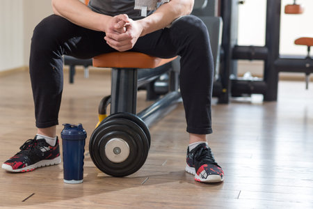 Horizontal view of dumbell and sporty shoes