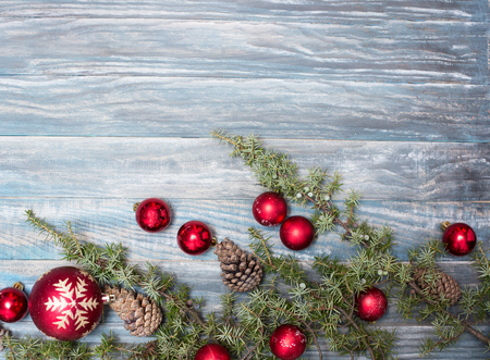 Red Christmas ornaments in the form of a Xmas tree on a rustic wooden background. Merry christmas card. Happy New Year. Top view with copy spaceの写真素材