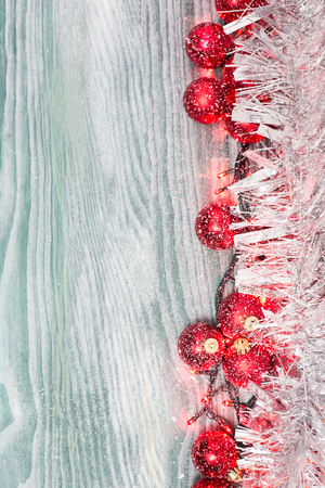 Gold Christmas bells and fir tree branch on a rustic wooden background. Xmas card. Happy New Year. Top view with copy spaceの写真素材