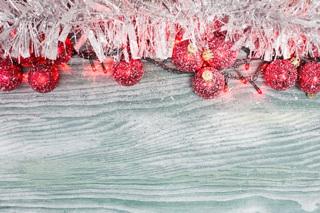 Gold Christmas bells and fir tree branch on a rustic wooden background. Xmas card. Happy New Year. Top view with copy spaceの写真素材