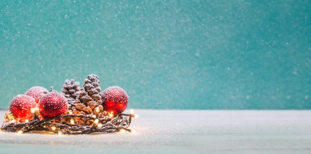 Christmas decorations with candles and pine cornの写真素材