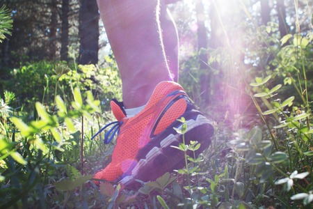 Close up of man walking on nature trail near forest preserve. Color image, copy space, male walking outside on a beautiful day in nature.Horizontalの写真素材